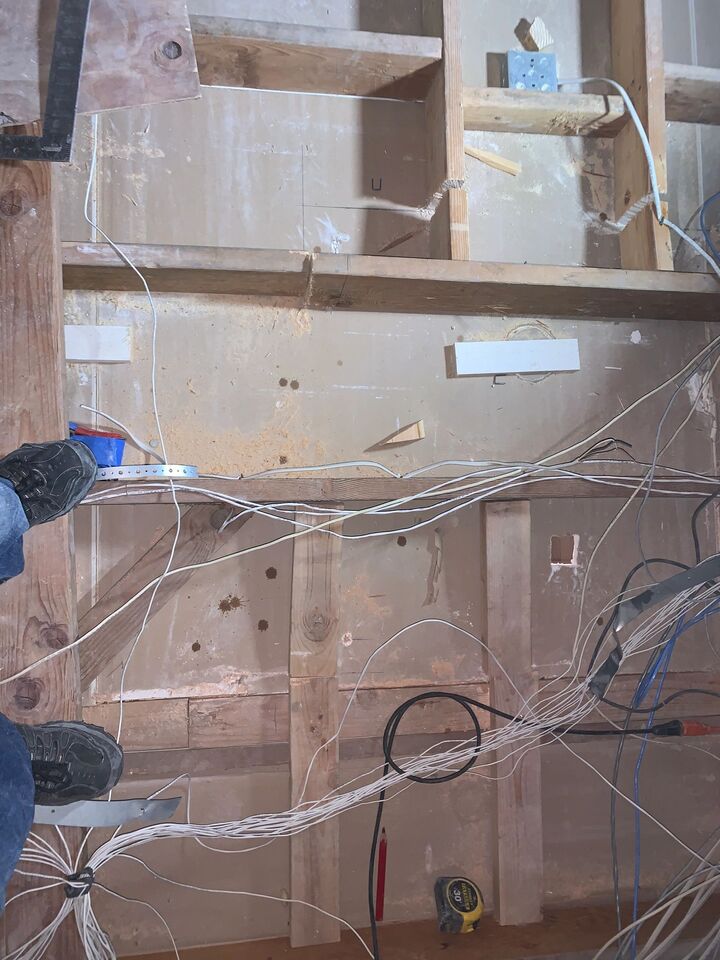 Inside the attic above the new opening, showing framing timbers and bundled cabling