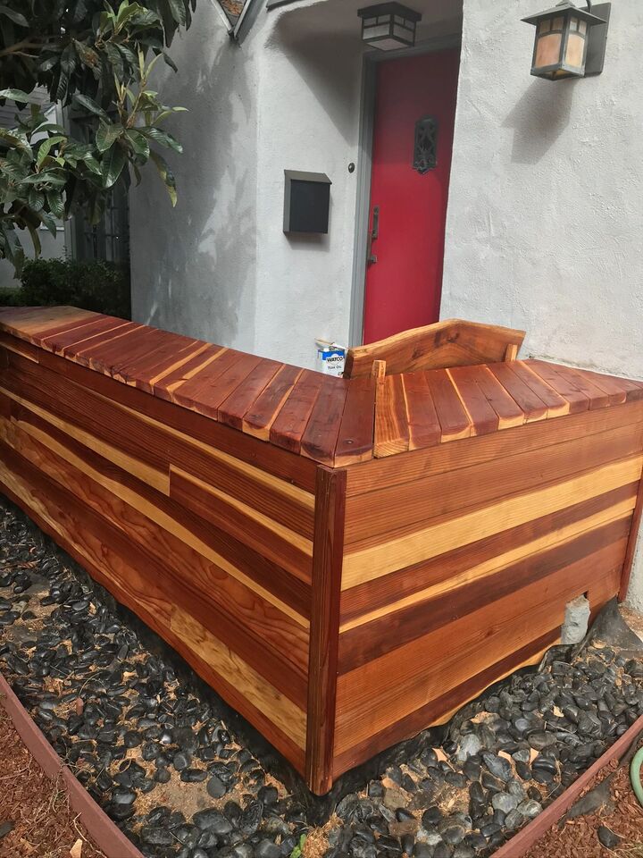 Deep red-brown stained deck with a raised step edge and horizontal skirt boards