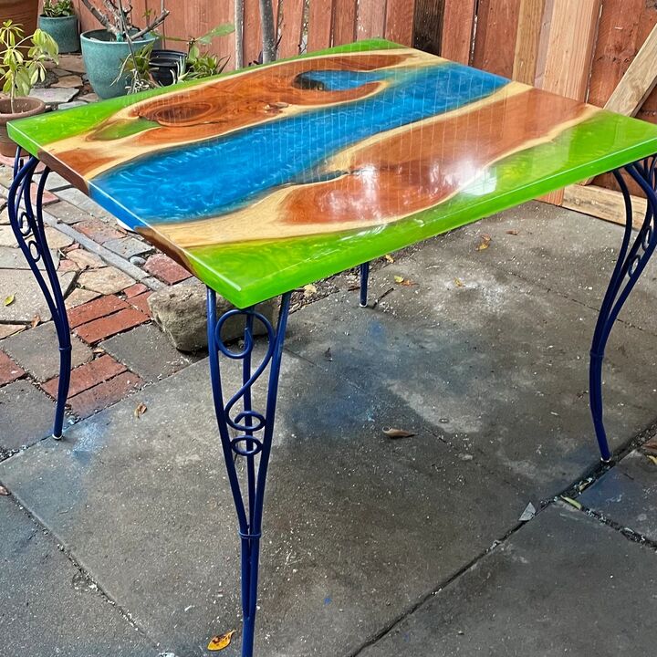 Overhead view of the green and blue resin table top showing the wood grain suspended in the pour