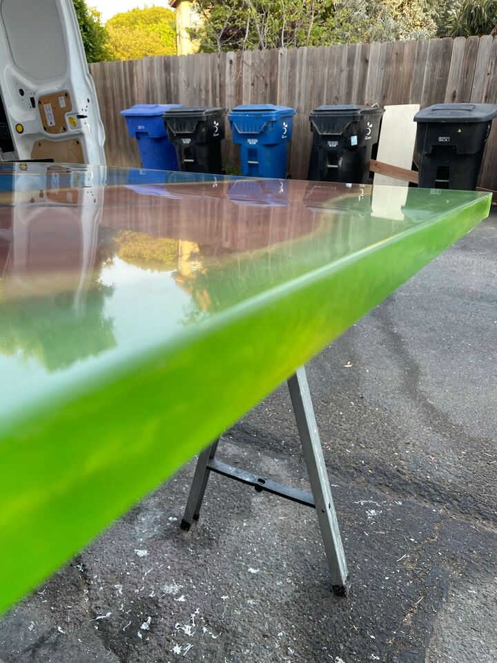 Edge-on view of the green resin table top showing the thickness and clarity of the cured pour