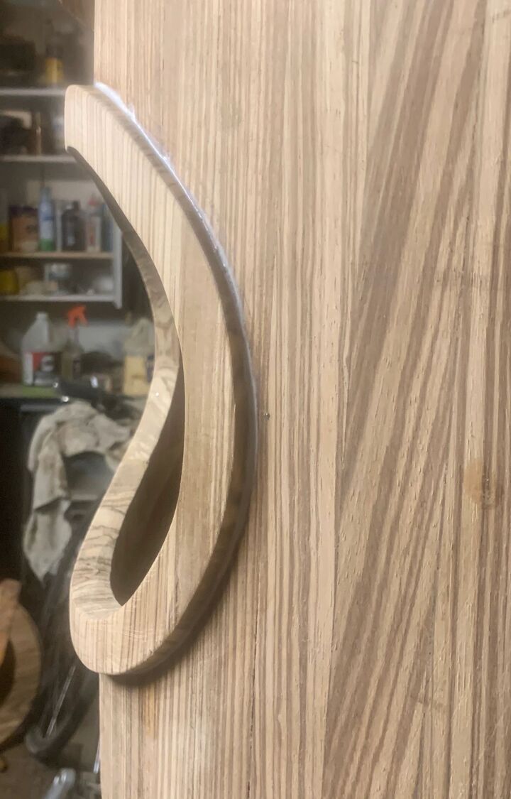 Shaped hardwood board with a carved curved handle detail