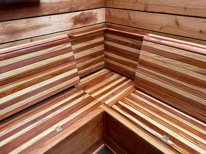 Close view of the redwood bench corner joint showing alternating light and dark board grain across seat and back