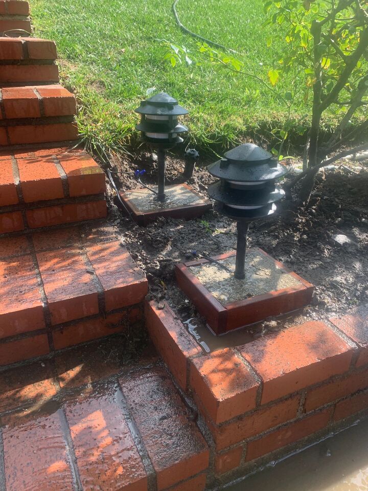 Brick and tile garden steps with lamp posts, freshly laid and still wet